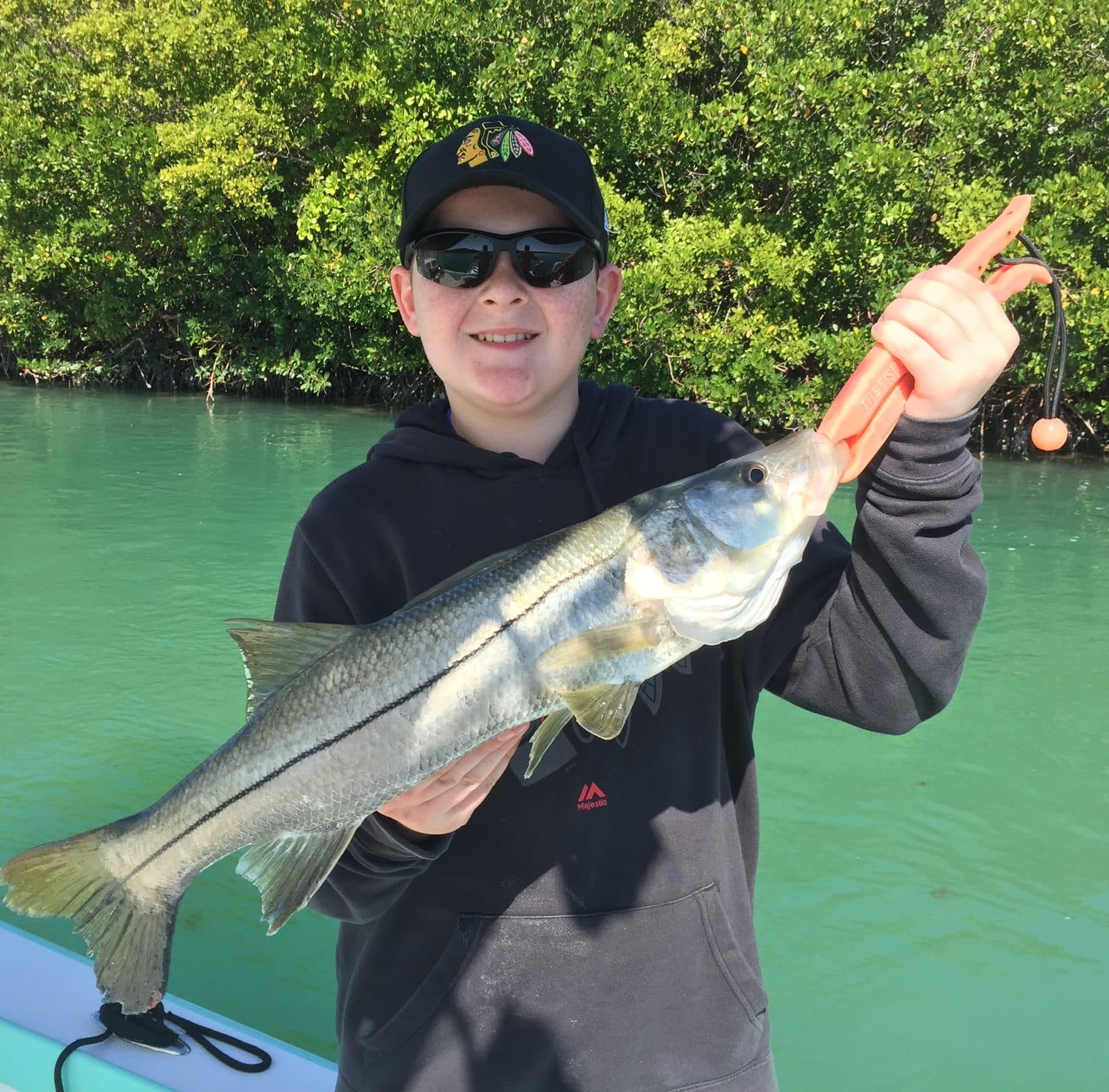 Young angler holding a snook