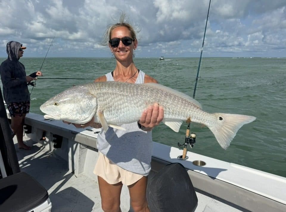 Angler holding a large redfish