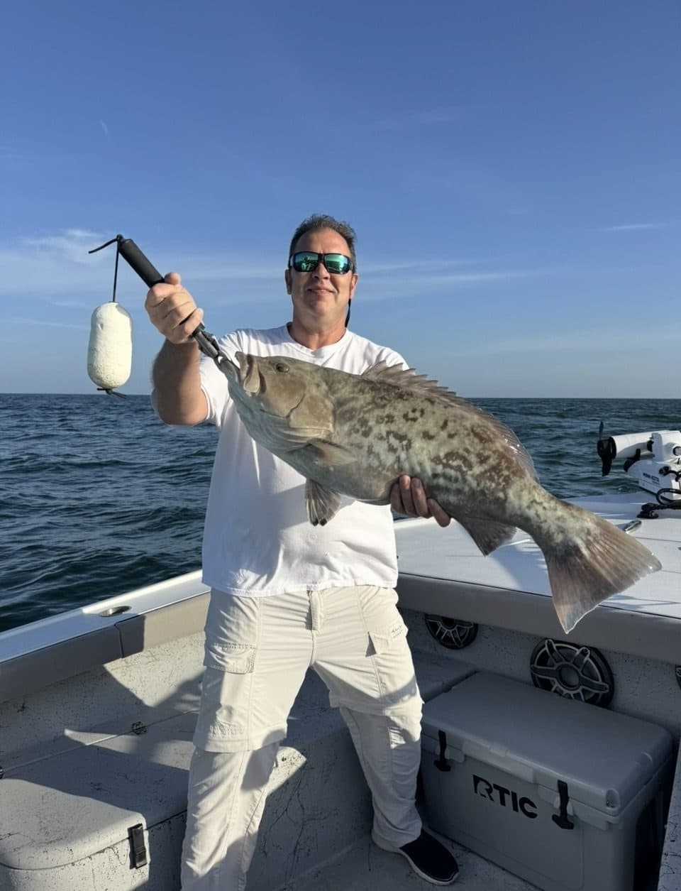 Angler holding a gag grouper