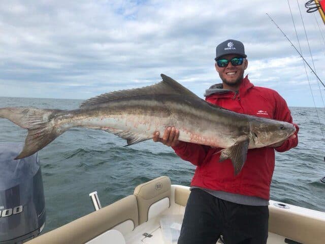 Angler holding a cobia on the bay boat